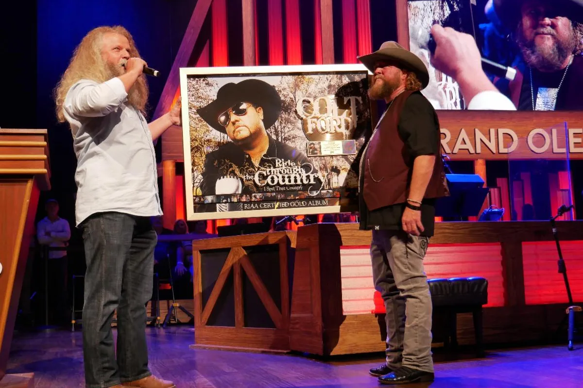 Jamey Johnson Surprises Colt Ford at the Grand Ole Opry with RIAA Award